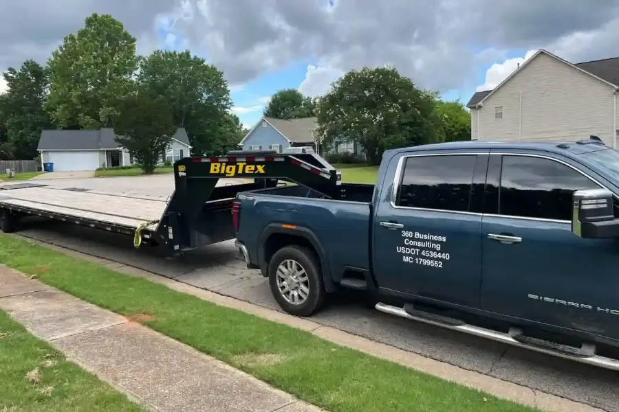 Pickup truck hauling a gooseneck flatbed trailer