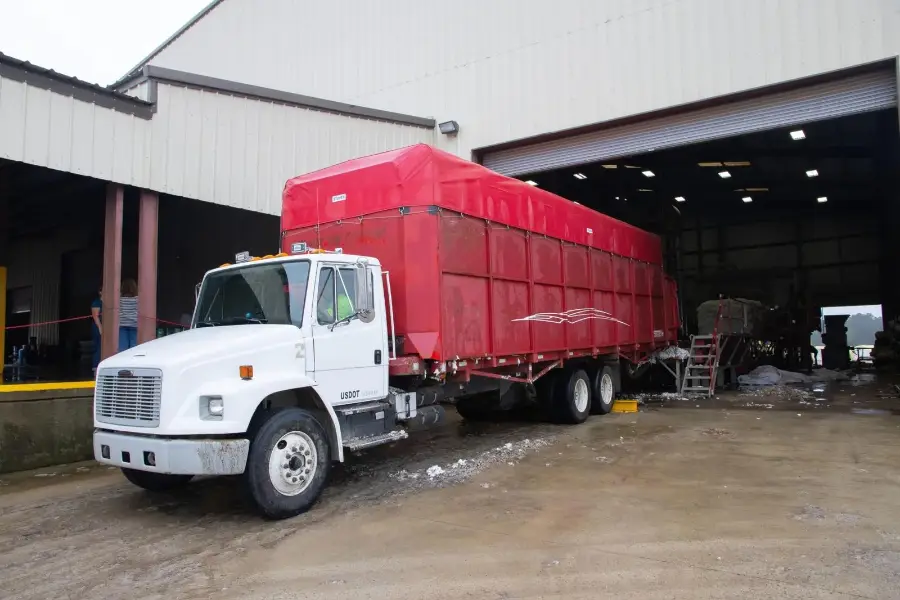 Truck with a tarped load at a warehouse loading dock